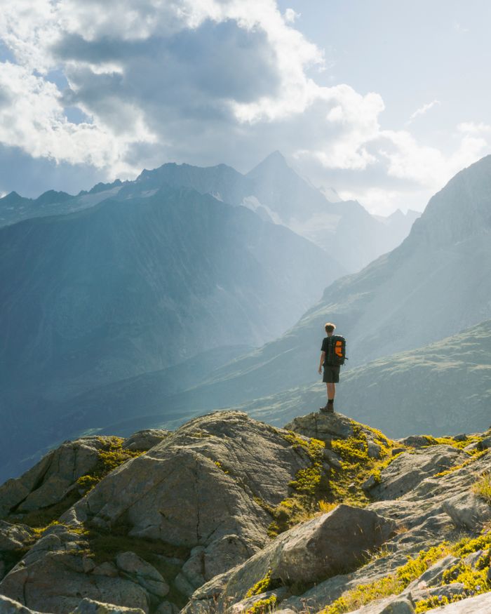 About A lone hiker enjoys the breathtaking alpine landscape in Bettmeralp, Switzerland.